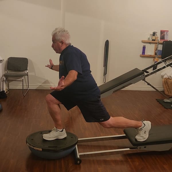 Client practicing balance training with Vancouver personal trainer Troy Tyrell at Tsquared studio.